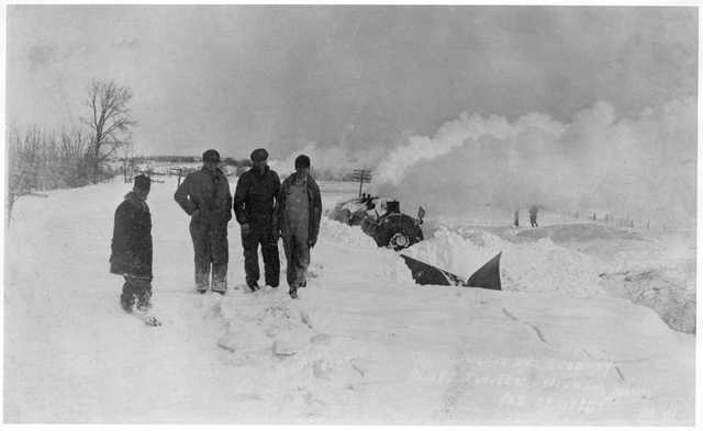 historical photo of a train caught in snow