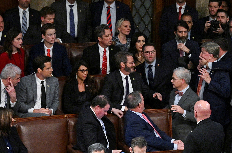 House Whip Tom Emmer, seated far left next to Rep. Matt Gaetz, watching as Rep. Mike Rogers is restrained by fellow House members during the vote for House Speaker on January 6.