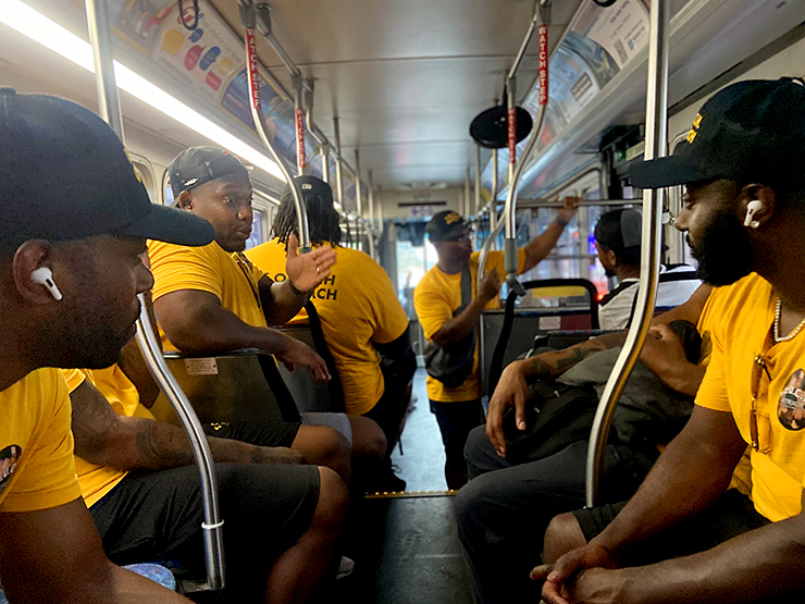 Shift lead Saaundre Burns, second from left, lays out the plan for the 3 pm to 11 pm shift