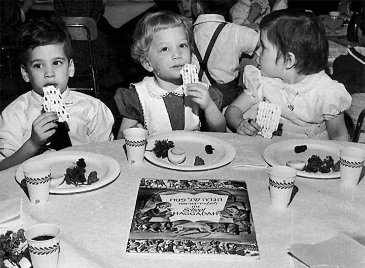 Scott Zuckman, Susan Hoffman and Lisa Savitt attending a Passover seder at the St. Paul Talmud Torah in 1960.