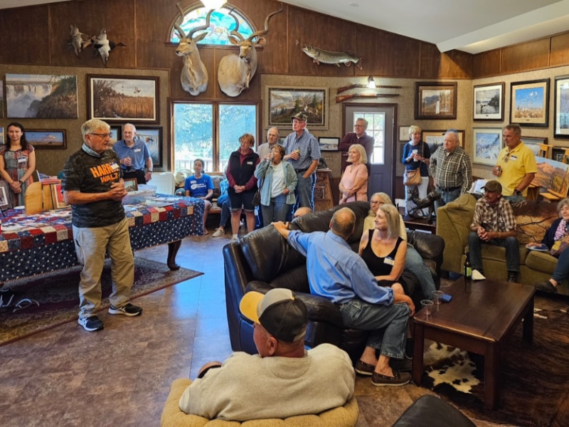 Community members gather at Michael Sieve's gallery in Houston County for a Hunters for Harris event.