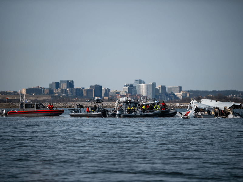U.S. Coast Guard, along with other search and rescue teams, operating on Thursday near debris at the crash site in the Potomac River in the aftermath of the collision of American Eagle flight 5342 and a Black Hawk helicopter.