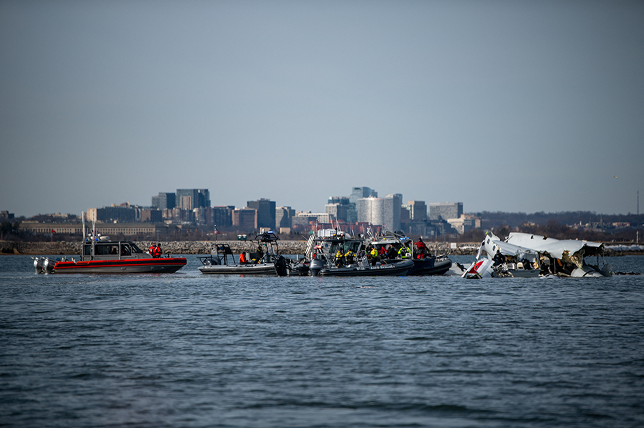 U.S. Coast Guard, along with other search and rescue teams, operating on Thursday near debris at the crash site in the Potomac River in the aftermath of the collision of American Eagle flight 5342 and a Black Hawk helicopter.