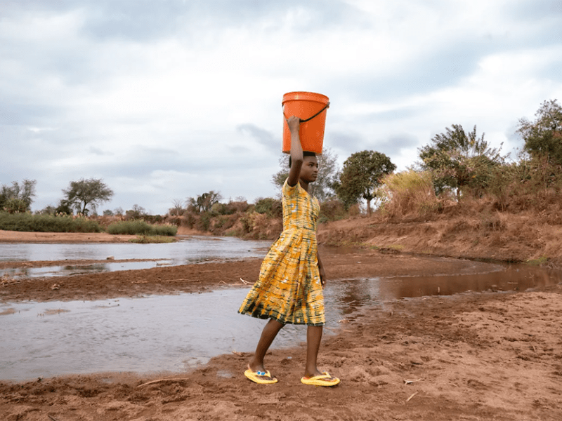 Gladys, a 13-year-old girl living in Golomoti, a community in Malawi, collects water for her family’s daily use.