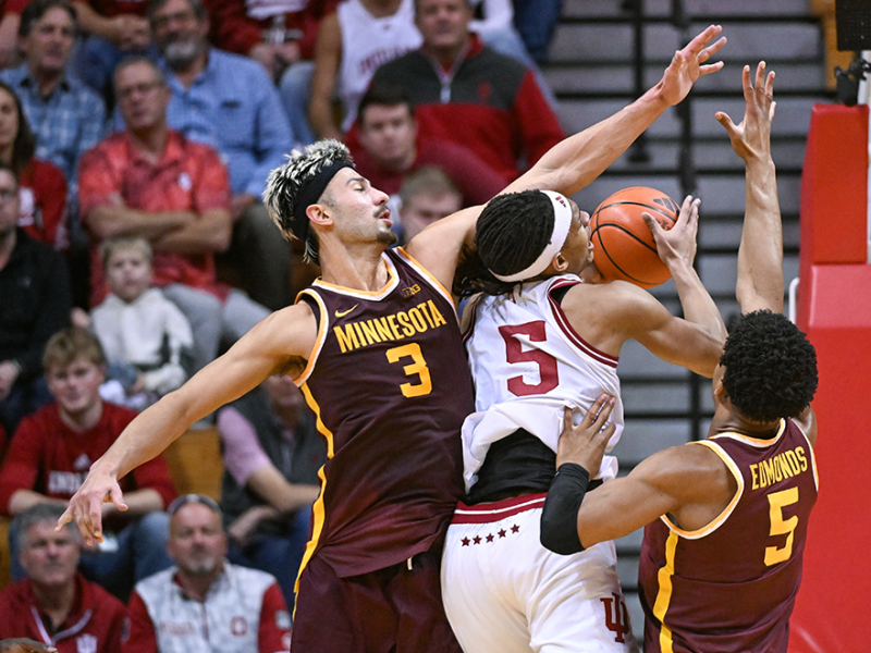 Indiana Hoosiers forward Malik Reneau driving to the basket against Golden Gophers forward Dawson Garcia, left, and center Trey Edmonds, right, during the second half at Simon Skjodt Assembly Hall in Bloomington, Indiana, on Dec. 9, 2024.