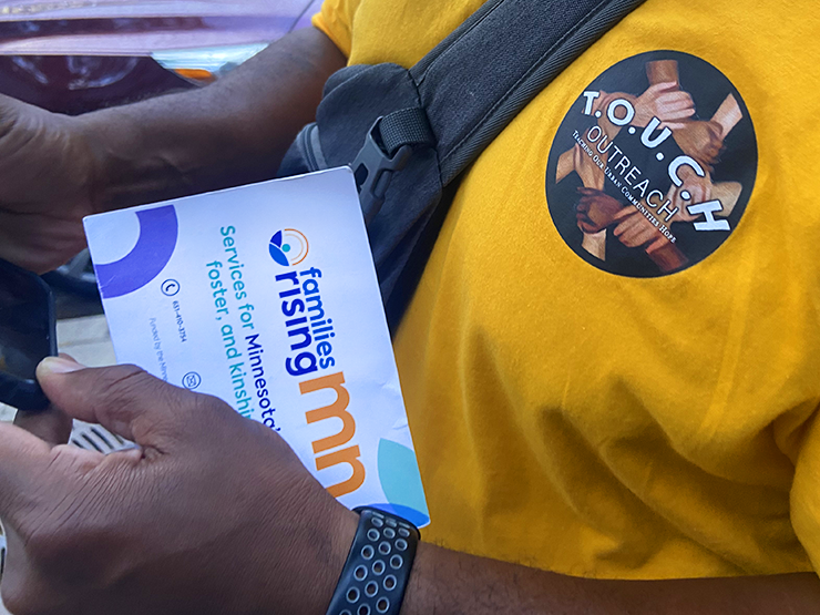 T.O.U.C.H. Outreach members pass out flyers offering information on a local homeless shelter.