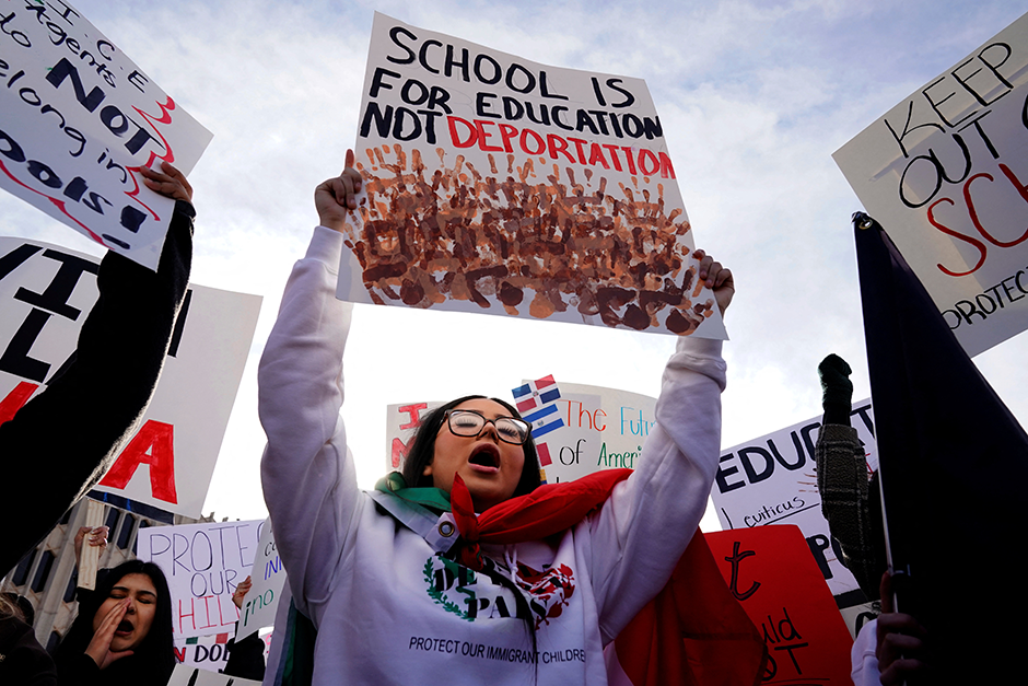 Protesters opposing possible Immigration and Customs Enforcement raids in public schools chant outside the State Department of Education during their monthly board meeting in Oklahoma City, Oklahoma, on Tuesday.