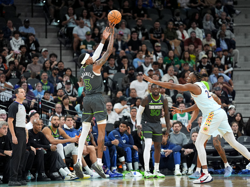 Timberwolves forward Jaden McDaniels shooting over San Antonio Spurs center Charles Bassey in the second half at Frost Bank Center on Sunday.