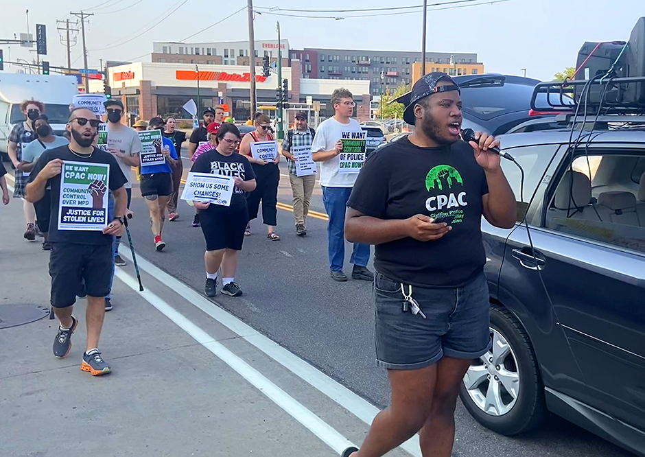 Jae Yates, right, leading a march on Thursday to launch a second effort to amend the city charter and establish the Civilian Police Accountability Commission.