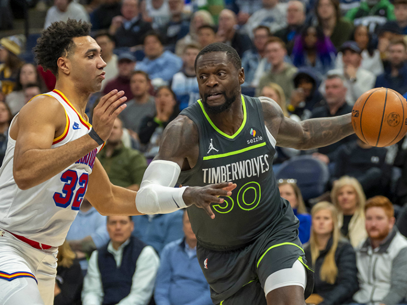 Timberwolves forward Julius Randle, right, dribbling past Golden State Warriors forward Trayce Jackson-Davis in the first half at Target Center on Wednesday.