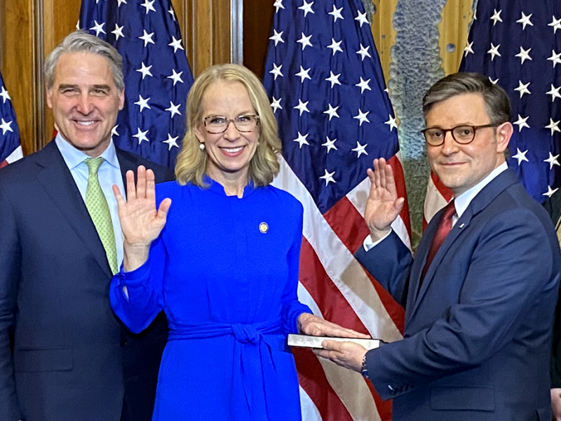 Kelly Morrison, second from left, shown during the ceremonial swearing-in on Friday. Speak Mike Johnson is at right and Morrison’s husband, John Willoughby, is at left.