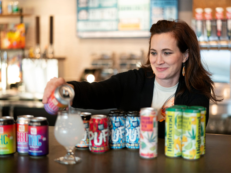 Laura Mullen, co-founder of Bent Paddle Brewing Co., displaying cannabis drink options available at the taproom in Duluth.