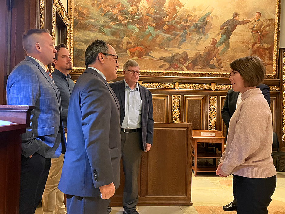 Gov. Walz’s deputy chief of staff Leah Montgomery, far right, speaking with, from left, state Reps. Ben Bakeberg, Max Rymer, Jon Koznick, and Paul Anderson in front of the Civil War painting “The Fifth Minnesota at Corinth.”