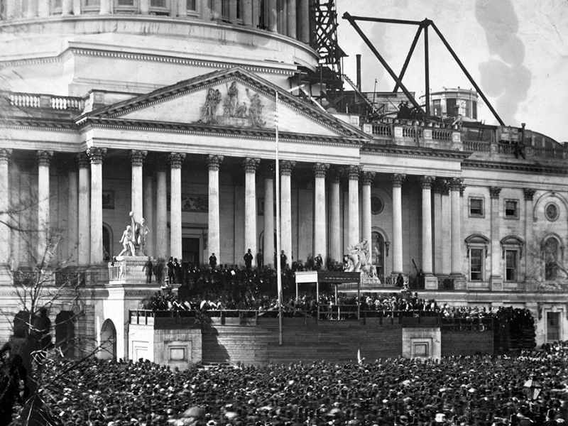 A photograph from an unknown photographer showing participants and the crowd at the first inauguration of President Abraham Lincoln at the U.S. Capitol.