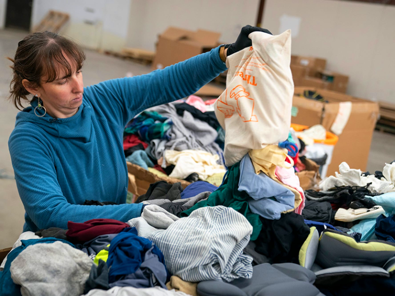 Rebecca Hayes sorts clothing on Tuesday, Dec. 17, 2024, at the Ridwell facility in St. Paul.