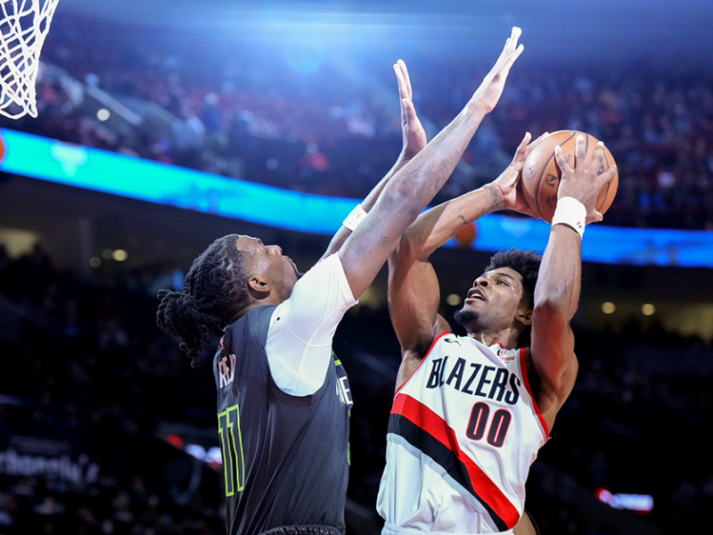 Portland Trail Blazers guard Scoot Henderson, right, shooting against Minnesota Timberwolves center Naz Reid during the first half at Moda Center in Portland on Wednesday.