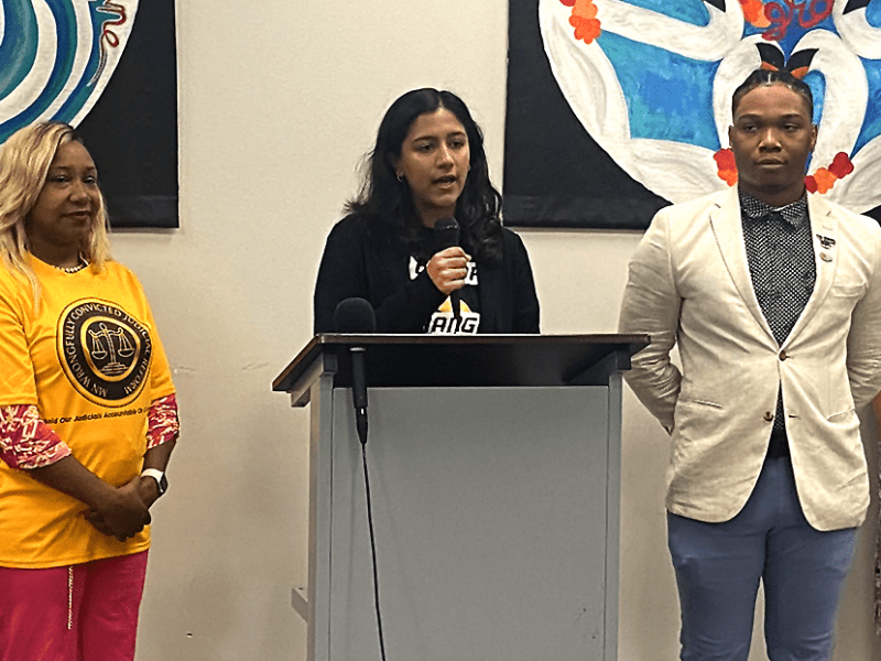 Color Of Change policy and government affairs manager Shruti Lakshmanan speaking at Thursday morning’s press conference as Minnesota Wrongfully Convicted Judicial Reform executive director Marvina Haynes and Black Community Board Minnesota founder Hassan As-Sidiq look on.