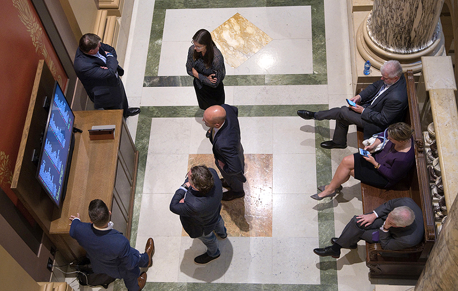 Lobbyists shown standing in the hallway outside the Minnesota Senate.