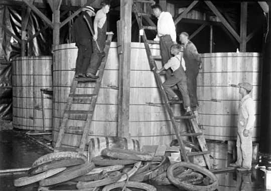 A group of people dismantling a still at Pillsbury and Charles Streets in St. Paul, c.1925.