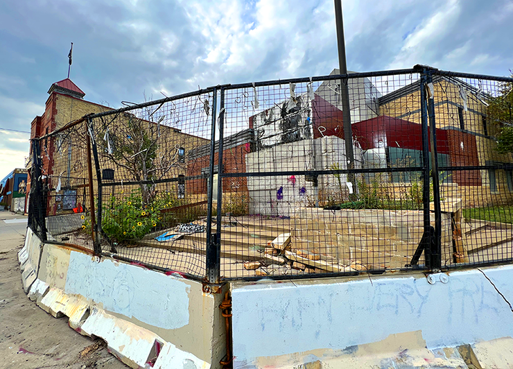 Minneapolis’ former Third Precinct Police Station at Lake Street & Minnehaha Avenue, surrounded by barricades and razor wire.