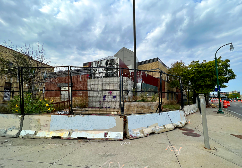 Minneapolis’ former Third Precinct Police Station at Lake Street & Minnehaha Avenue, surrounded by barricades and razor wire.