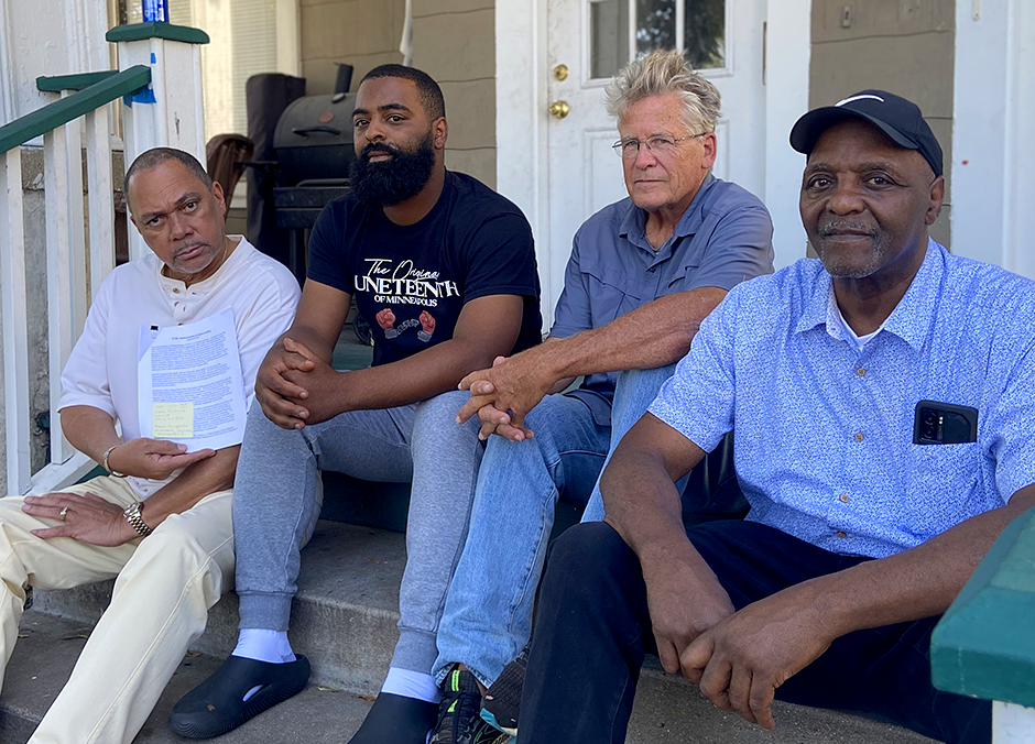 From left: Rev. Ian Bethel, Alfred Flowers Jr., Mark Anderson and Al Flowers, members of the Unity Community Mediation Team. Bethel is holding up the Memorandum of Understanding between the UCMT and the Minneapolis Police Department.