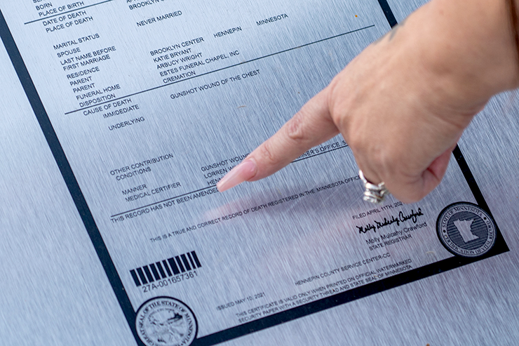 Katie Wright pointing out an error on Daute’s death certificate engraving that she intends to fix.